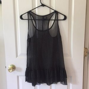 Sheer black tank with white polka dots.